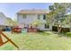 View of the home's backyard and wooden deck, perfect for outdoor relaxation and entertaining at 1480 Bramlett Forest Se Trl, Lawrenceville, GA 30045
