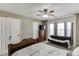 Cozy bedroom with a ceiling fan, a bed, sofa, and dresser for a comfortable retreat at 1480 Bramlett Forest Se Trl, Lawrenceville, GA 30045