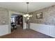 Well-lit dining room featuring decorative wallpaper, wainscoting and an elegant chandelier at 1480 Bramlett Forest Se Trl, Lawrenceville, GA 30045