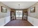 Elegant dining room with decorative wallpaper, wainscoting, and classic furniture at 1480 Bramlett Forest Se Trl, Lawrenceville, GA 30045