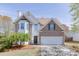 Charming two-story home boasts a two-car garage and well-maintained front yard at 1480 Bramlett Forest Se Trl, Lawrenceville, GA 30045