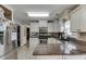 Charming kitchen with stainless appliances, granite counters, and white cabinets in a cozy setting at 1480 Bramlett Forest Se Trl, Lawrenceville, GA 30045