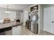Bright kitchen area featuring stainless steel refrigerator, white cabinets, and granite countertops at 1480 Bramlett Forest Se Trl, Lawrenceville, GA 30045