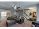 Inviting living room with a comfortable sofa and view of the staircase and dining area at 1480 Bramlett Forest Se Trl, Lawrenceville, GA 30045