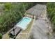 Aerial shot featuring a community pool and tennis courts, surrounded by lush greenery, offering recreational amenities at 1480 Bramlett Forest Se Trl, Lawrenceville, GA 30045