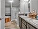 Bright bathroom featuring a tub, a shower, and a double sink vanity with granite countertops at 2466 Monroe Jersey Rd, Covington, GA 30014