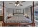 Large bedroom with a four-poster bed and an adjacent ensuite bathroom with a modern vanity at 2466 Monroe Jersey Rd, Covington, GA 30014