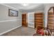 Bedroom featuring neutral walls, carpet, bookshelves and a picture window offering natural light at 2466 Monroe Jersey Rd, Covington, GA 30014