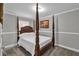 Bedroom featuring a four-poster bed, crown molding, and a neutral color scheme at 2466 Monroe Jersey Rd, Covington, GA 30014