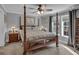 Cozy bedroom with four-poster bed, ceiling fan, and neutral decor at 2466 Monroe Jersey Rd, Covington, GA 30014