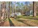Wide angle shot of yard, shed and single story home nestled in the trees at 2466 Monroe Jersey Rd, Covington, GA 30014
