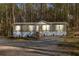 Charming single-story home with a lush, wooded backdrop and well-maintained front yard at 2466 Monroe Jersey Rd, Covington, GA 30014