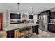 Modern kitchen with stainless steel appliances, granite countertops, and dark cabinets at 2466 Monroe Jersey Rd, Covington, GA 30014