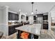 Modern kitchen with stainless steel appliances, large island, and dark wood cabinets at 2466 Monroe Jersey Rd, Covington, GA 30014
