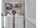 Functional laundry room with modern white appliances and ample storage space at 2466 Monroe Jersey Rd, Covington, GA 30014