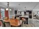 Open floor plan connecting the dining room and kitchen with stainless steel appliances at 2466 Monroe Jersey Rd, Covington, GA 30014