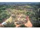 Expansive aerial view showcasing the homes, lush surrounding forest, and the neighborhood at 313 Morgan Rd, Temple, GA 30179