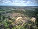 Expansive aerial view showcasing the homes, lush surrounding forest, and the neighborhood at 313 Morgan Rd, Temple, GA 30179