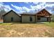 Back of house showcasing an outdoor living area with a covered patio and wooden ceiling at 313 Morgan Rd, Temple, GA 30179