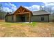 Back of house showcasing an outdoor living area with a covered patio and wooden ceiling at 313 Morgan Rd, Temple, GA 30179