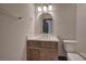 Modern bathroom featuring a vanity with light wood cabinets, white countertops, and a gold faucet and mirror at 313 Morgan Rd, Temple, GA 30179