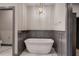 Bathroom featuring a soaking tub, marble floors, and modern lighting at 313 Morgan Rd, Temple, GA 30179