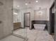 Modern bathroom featuring a glass shower, dual sinks, and a luxurious soaking tub at 313 Morgan Rd, Temple, GA 30179