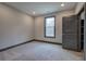 Cozy bedroom with gray carpet, a gray accent wall, and a window overlooking the outdoors at 313 Morgan Rd, Temple, GA 30179