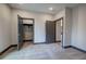 Neutral bedroom featuring carpet, baseboard trim and two open gray doors at 313 Morgan Rd, Temple, GA 30179