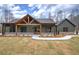 Charming, modern home with a covered porch, exposed beams, stone accents, and a well-manicured lawn at 313 Morgan Rd, Temple, GA 30179