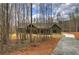 Beautiful, modern home featuring a covered porch with exposed beams, set on a large wooded lot at 313 Morgan Rd, Temple, GA 30179