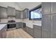Well-lit kitchen with gray cabinets and stainless steel appliances at 313 Morgan Rd, Temple, GA 30179