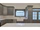 Modern kitchen featuring gray cabinetry, stainless steel appliances, and a stylish awning window at 313 Morgan Rd, Temple, GA 30179