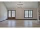 Large living area featuring hardwood floors, double doors, and a bright window with backyard views at 313 Morgan Rd, Temple, GA 30179