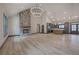 Bright living room with stone fireplace, hardwood floors, and modern chandelier at 313 Morgan Rd, Temple, GA 30179
