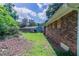 View of brick home with grassy backyard at 3932 Lindsey Dr, Decatur, GA 30035