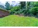 Large backyard featuring green grass and mature trees, ideal for outdoor activities and relaxation at 3932 Lindsey Dr, Decatur, GA 30035