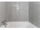 Modern bathroom boasts white subway tile walls and a tub at 3932 Lindsey Dr, Decatur, GA 30035