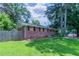 Charming brick home featuring a spacious lawn and mature trees creating a serene and private setting at 3932 Lindsey Dr, Decatur, GA 30035