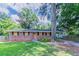 Traditional brick home with attached carport and well-maintained lawn at 3932 Lindsey Dr, Decatur, GA 30035