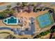 Aerial view showcases community pool, tennis courts, clubhouse, and ample parking, creating an active lifestyle at 4155 Cami Way, Buford, GA 30519