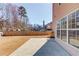 Spacious backyard featuring a wooden fence, concrete patio, and a view of surrounding trees at 4155 Cami Way, Buford, GA 30519