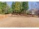 Large, grassy backyard features a privacy fence and space for gardening or recreation at 4155 Cami Way, Buford, GA 30519