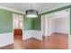 Inviting dining room with wainscoting, hardwood floors, open to the kitchen, perfect for entertaining at 4155 Cami Way, Buford, GA 30519