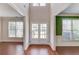 Inviting foyer featuring hardwood floors, complemented by green accent wall and natural light at 4155 Cami Way, Buford, GA 30519
