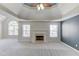 Spacious living room featuring a cozy fireplace and large windows for ample natural light at 4155 Cami Way, Buford, GA 30519