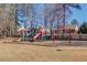 Community playground featuring colorful slides, swings and play structures surrounded by trees and backing up to community homes at 4155 Cami Way, Buford, GA 30519