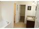 Bathroom with a walk-in closet, a vanity with granite countertop, and a bathtub at 1440 Gallup Dr, Stockbridge, GA 30281