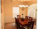 Formal dining room with a dark wood table, seating for eight, and elegant lighting at 1440 Gallup Dr, Stockbridge, GA 30281
