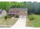 Charming two-story home with brick facade, two-car garage, and well-manicured lawn at 1440 Gallup Dr, Stockbridge, GA 30281